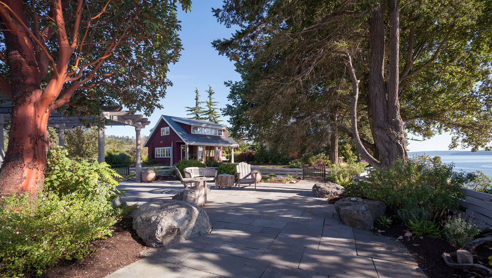 Inspiration for a large farmhouse side fully shaded garden in Seattle with a garden path and natural stone paving.