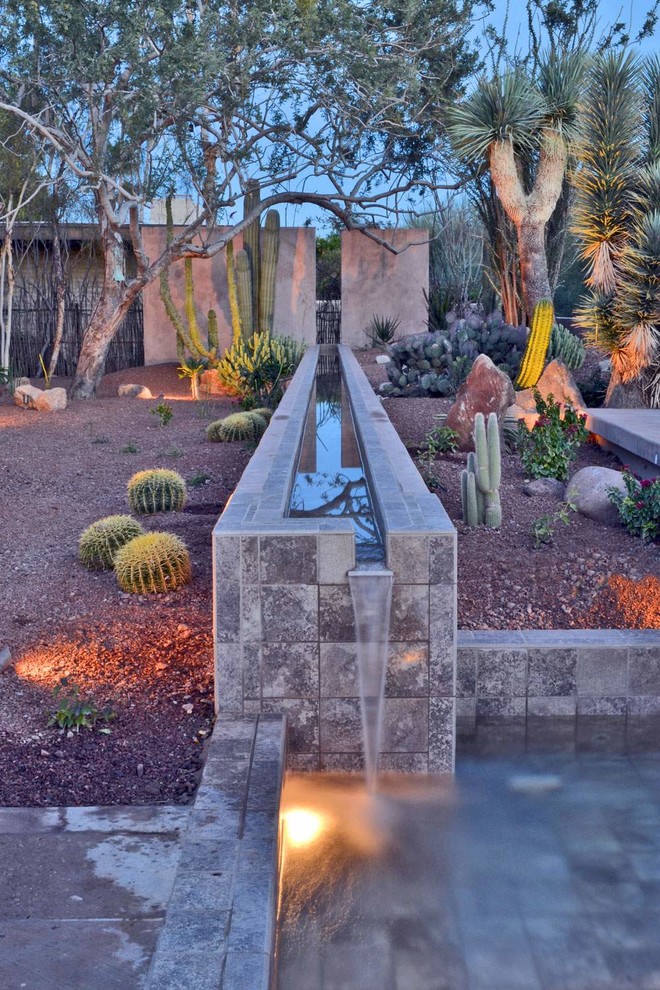 This is an example of a mediterranean full sun water fountain landscape in Phoenix.