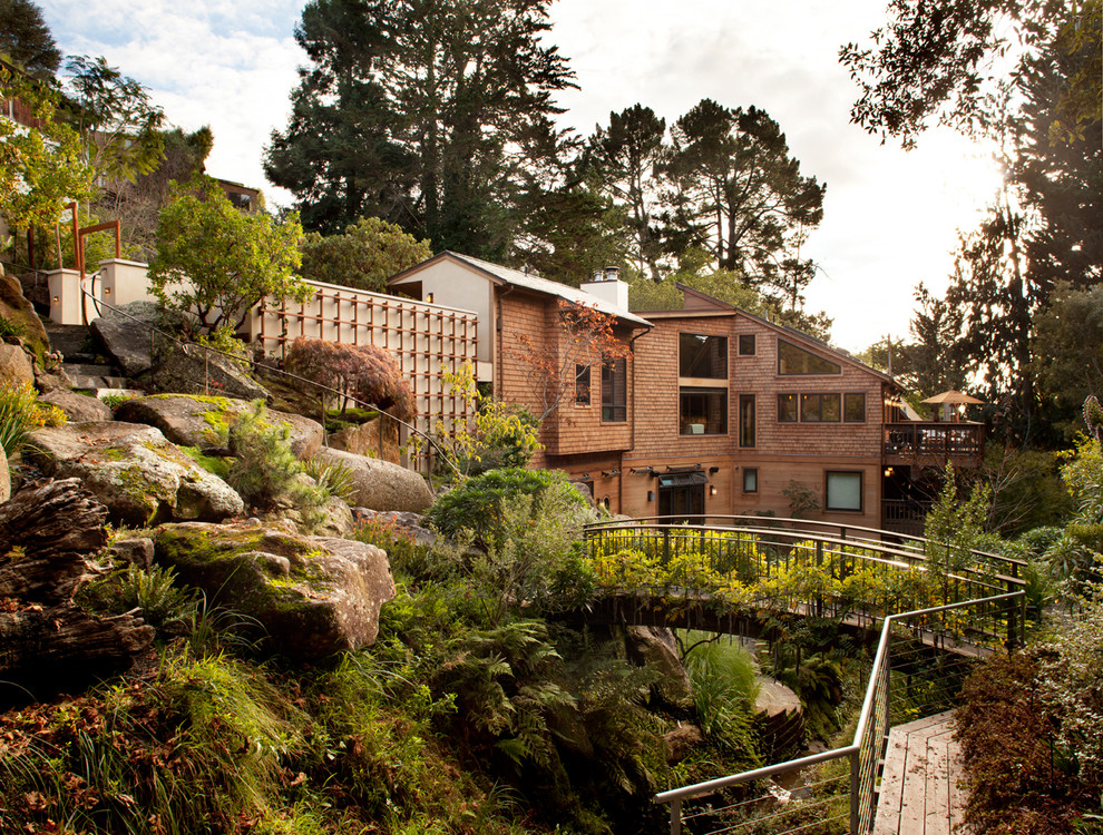 Design ideas for a large transitional shade hillside landscaping in San Francisco with decking.