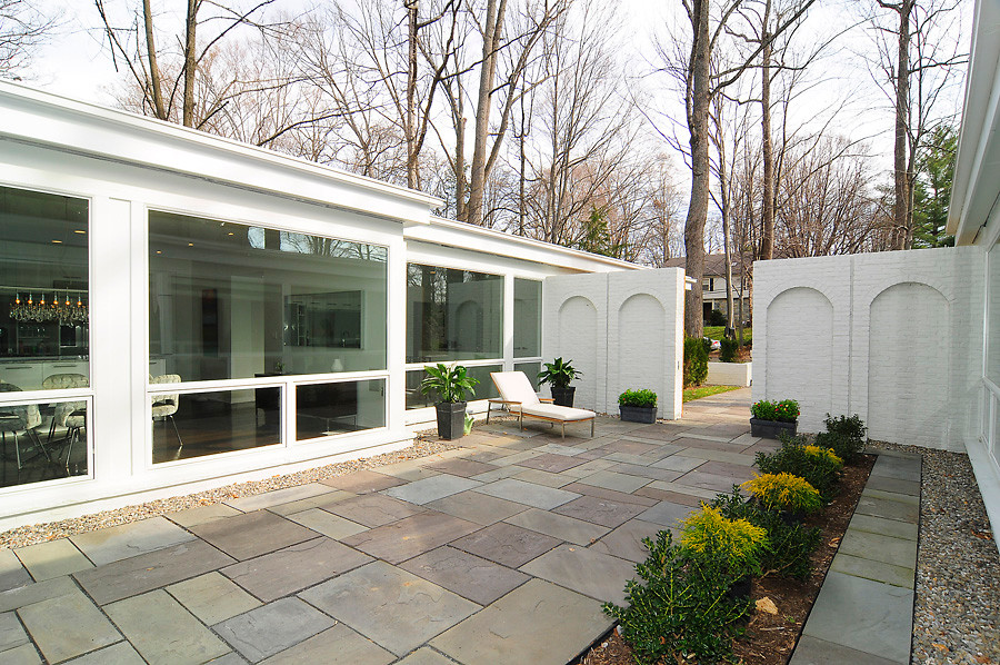 Photo of a mid-sized contemporary full sun courtyard concrete paver garden path in DC Metro for spring.
