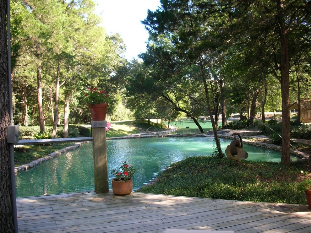 Design ideas for a large farmhouse back formal partial sun garden in Austin with a pond and decking.