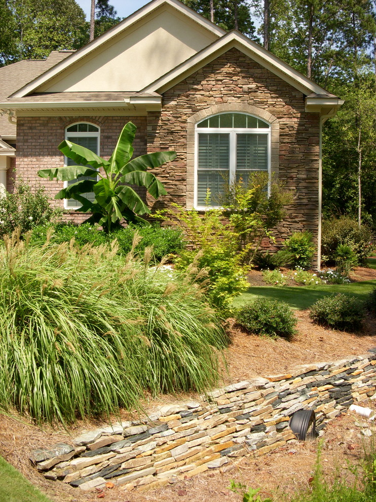 Inspiration for a traditional partial sun landscaping in Other.