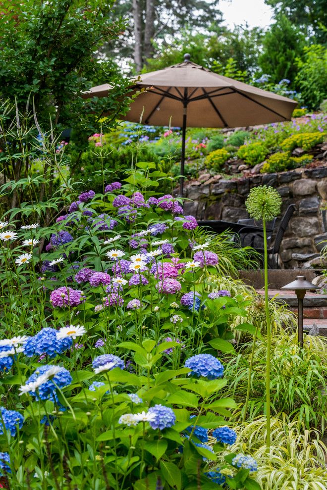 Diseño de jardín clásico extra grande en verano en ladera con exposición parcial al sol