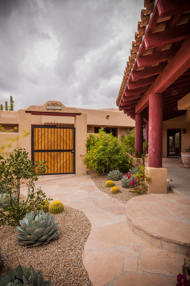 This is an example of a courtyard xeriscape garden in Phoenix with a garden path.
