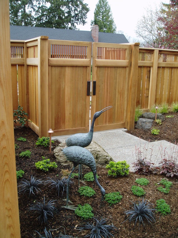 This is an example of a medium sized classic front partial sun garden in Portland with a garden path.