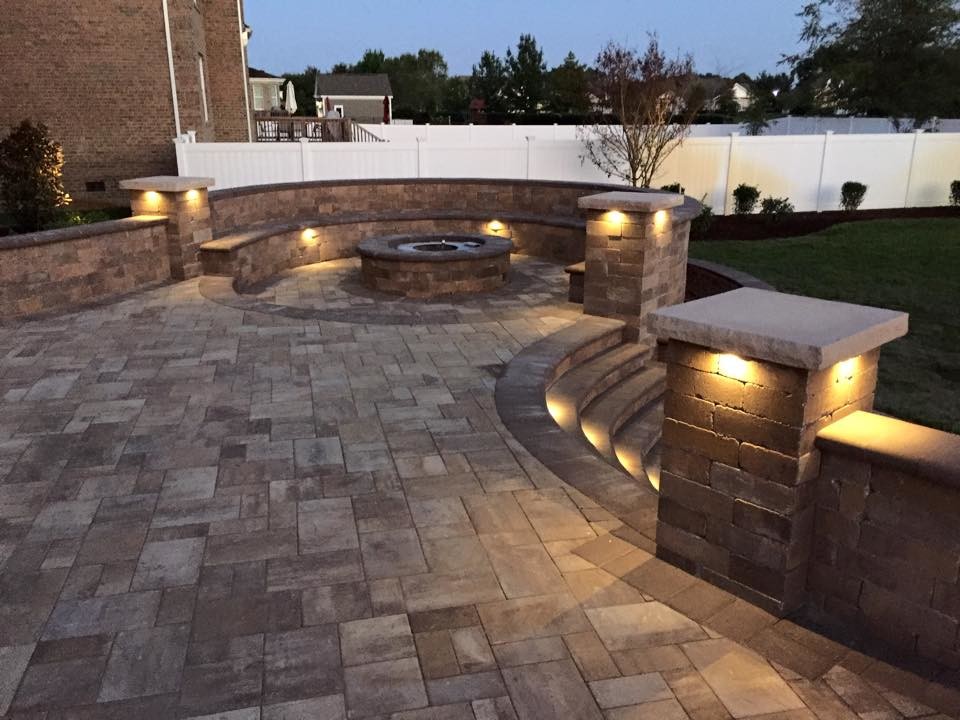 Example of a large classic backyard stone patio design in Other