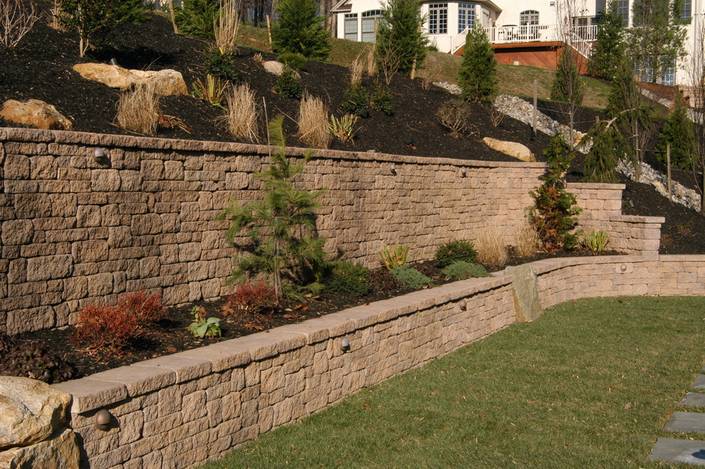 This is an example of a mid-sized rustic full sun backyard stone landscaping in Philadelphia for spring.