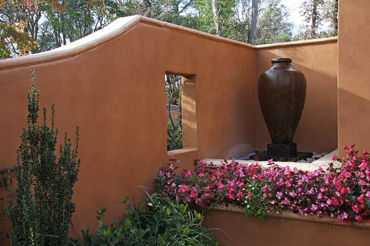 This is an example of a medium sized urban courtyard partial sun garden in Sacramento with natural stone paving.