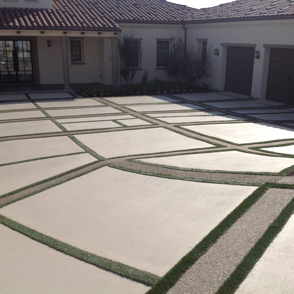 Photo of a large modern front driveway partial sun garden in San Diego with a potted garden and concrete paving.