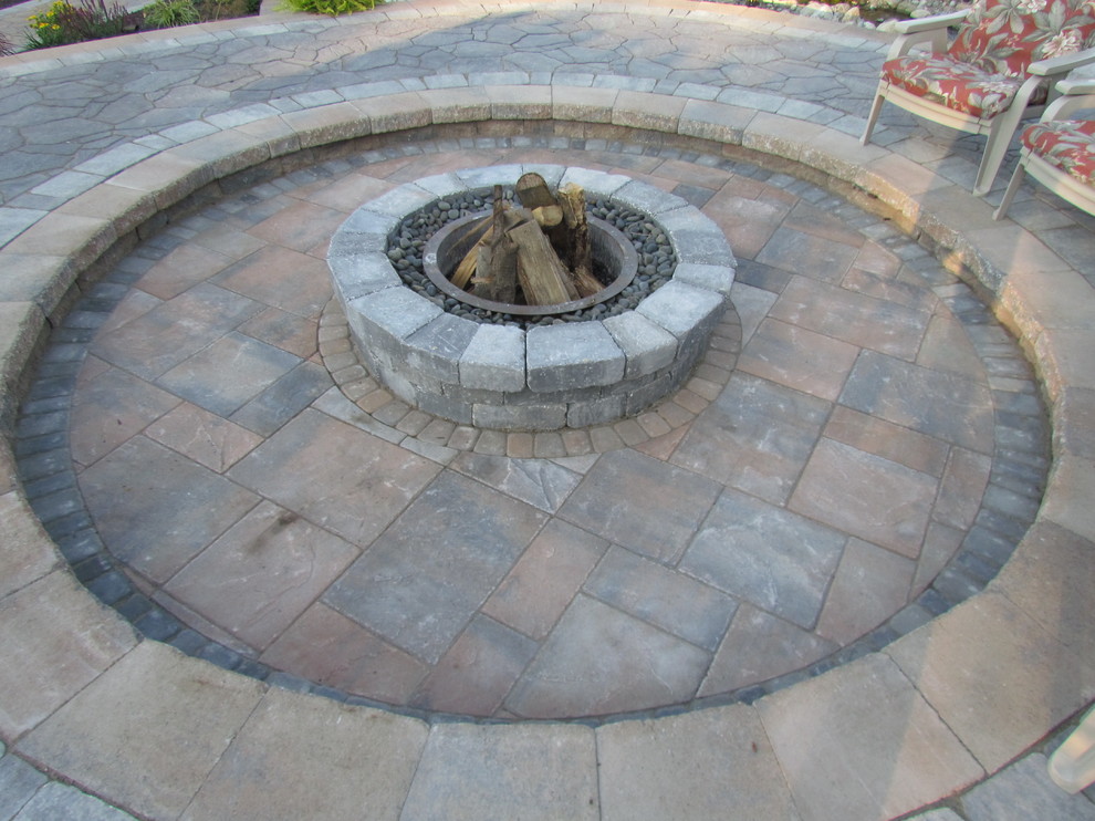 Design ideas for a traditional back patio in New York with a fire feature and concrete paving.