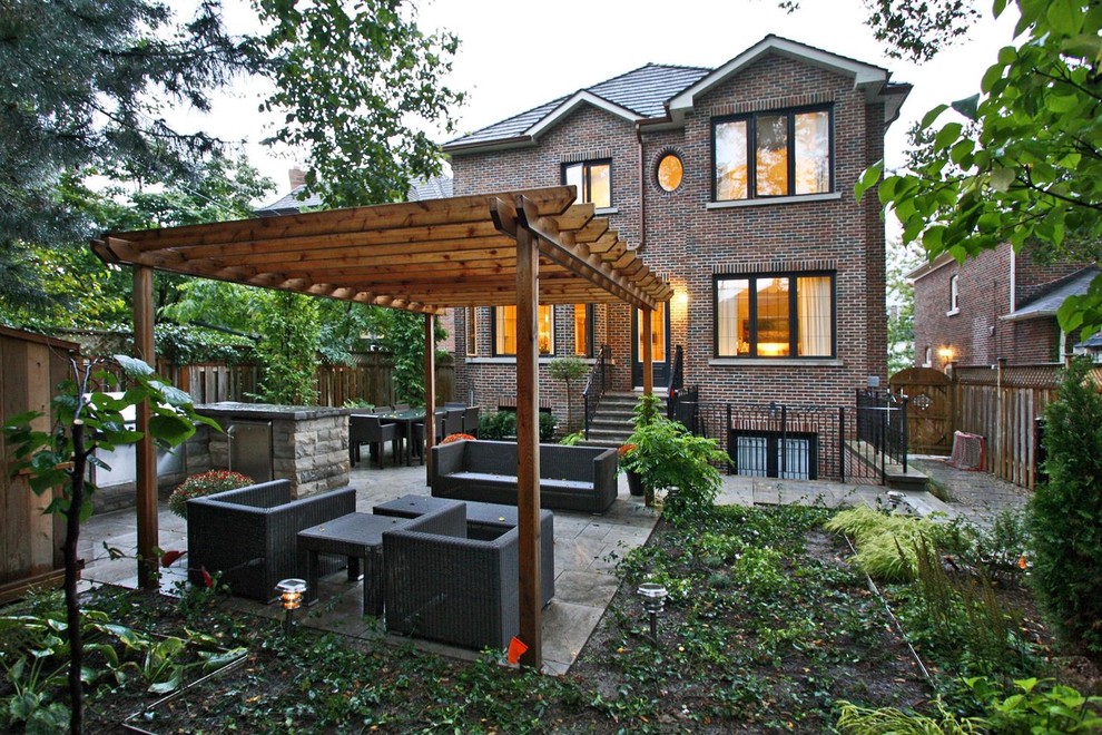 This is an example of a contemporary backyard landscaping in Toronto with a pergola.