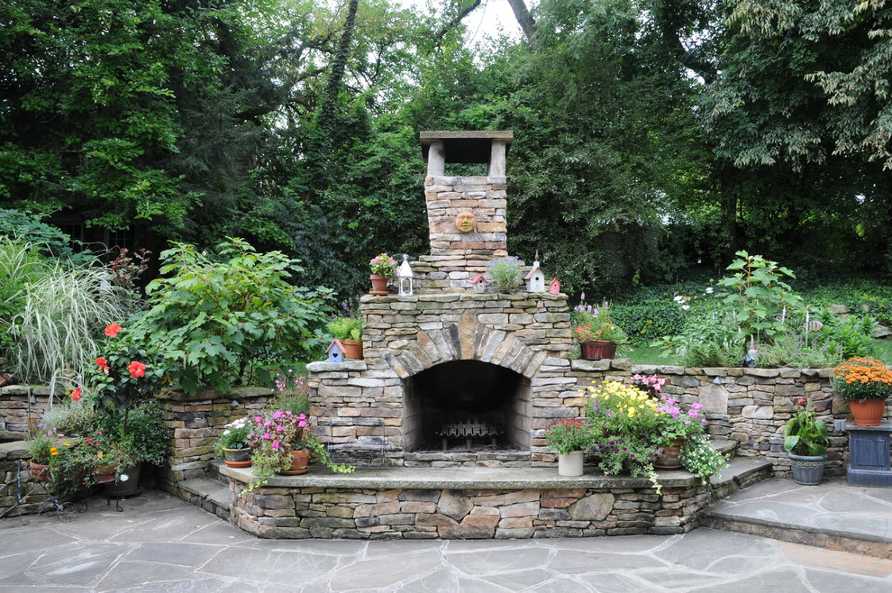Design ideas for an eclectic backyard stone landscaping in Other with a fire pit for fall.