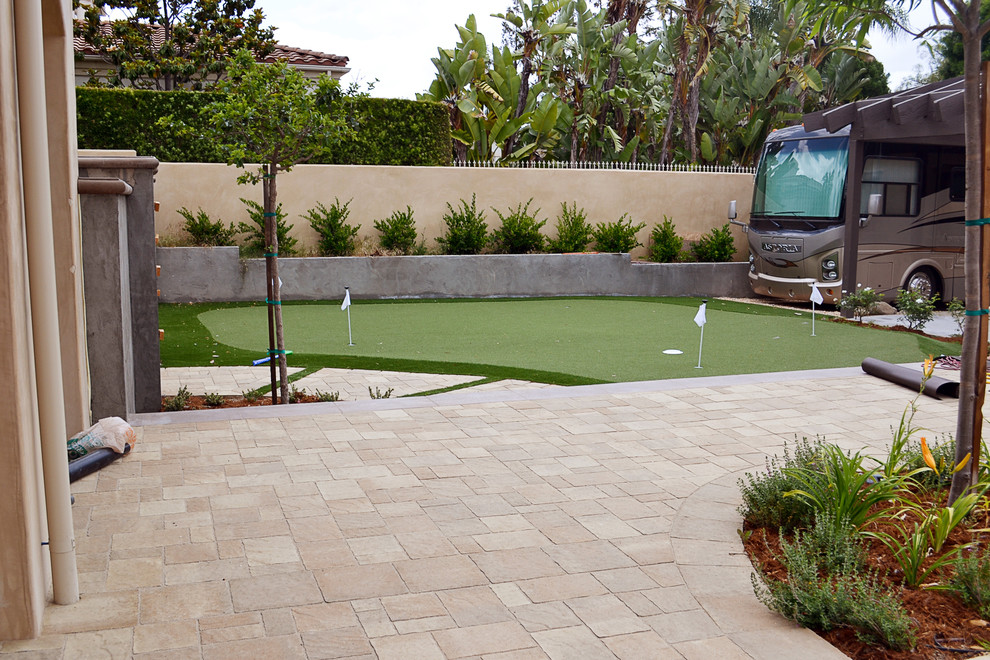 This is an example of a large classic side partial sun garden in Los Angeles with an outdoor sport court and concrete paving.