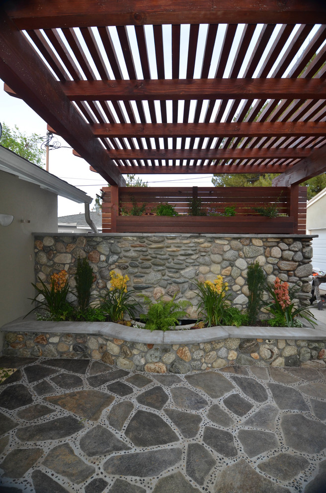 Photo of a small asian partial sun backyard stone landscaping in Los Angeles with a fire pit for spring.