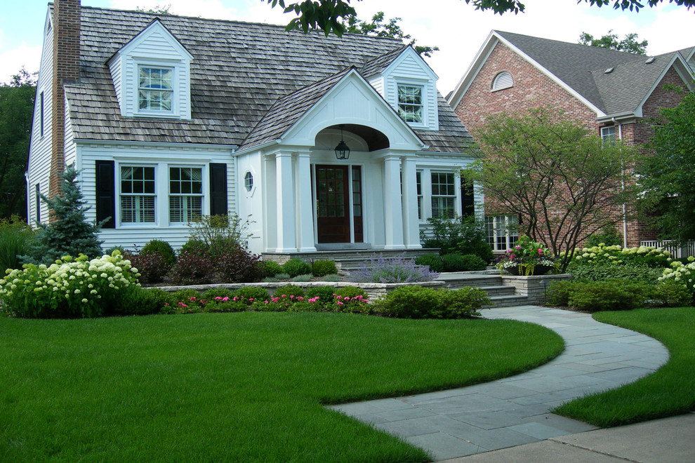 Inspiration for a classic front driveway full sun garden in Chicago with natural stone paving.