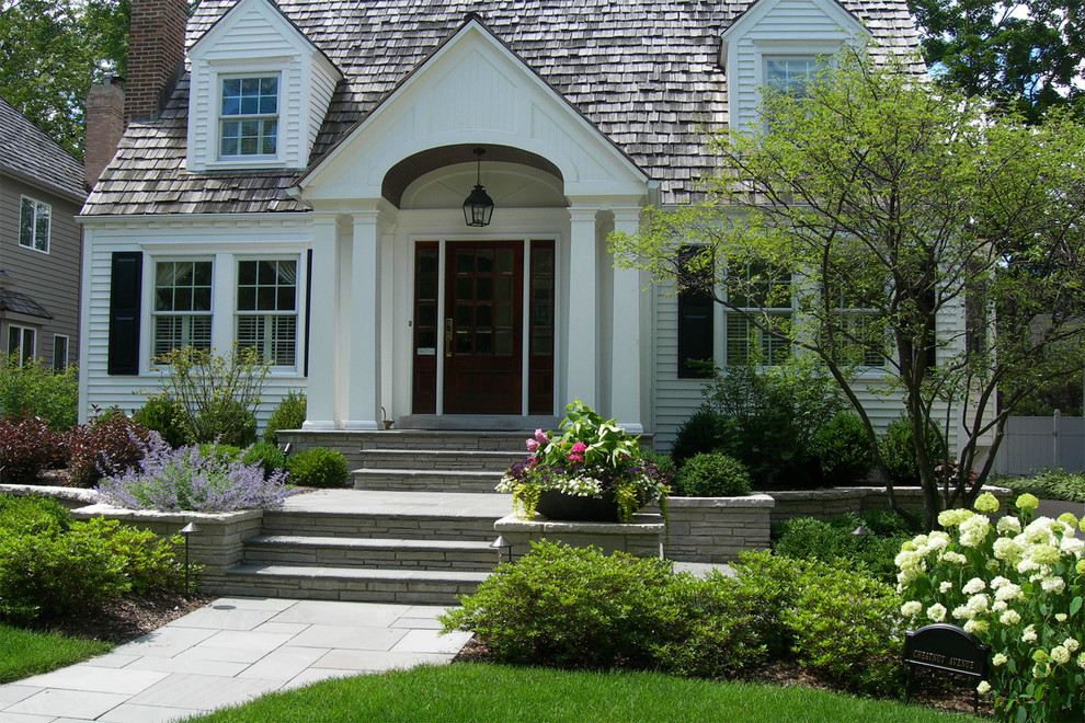 Photo of a classic front formal full sun garden in Chicago with natural stone paving and a garden path.