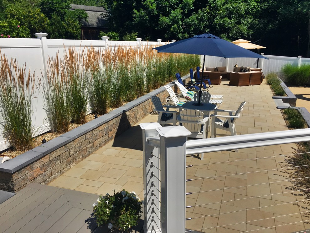 Photo of a small contemporary back full sun garden for summer in Boston with concrete paving.