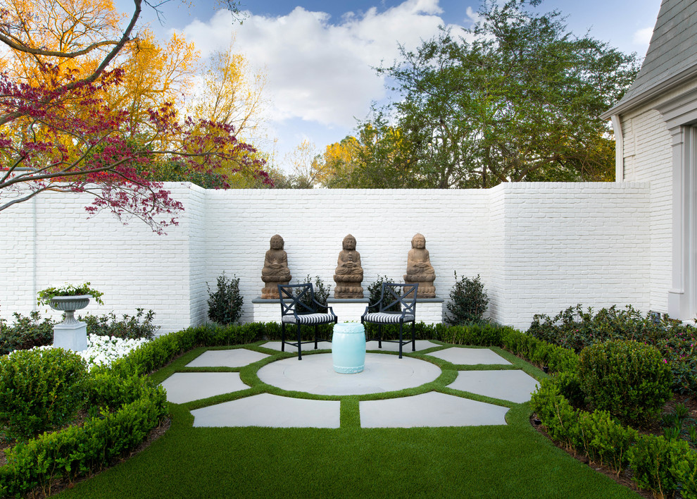 Photo of a traditional concrete paver formal garden in Dallas.