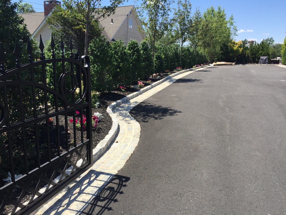 Photo of a partial sun front yard concrete paver driveway in New York.