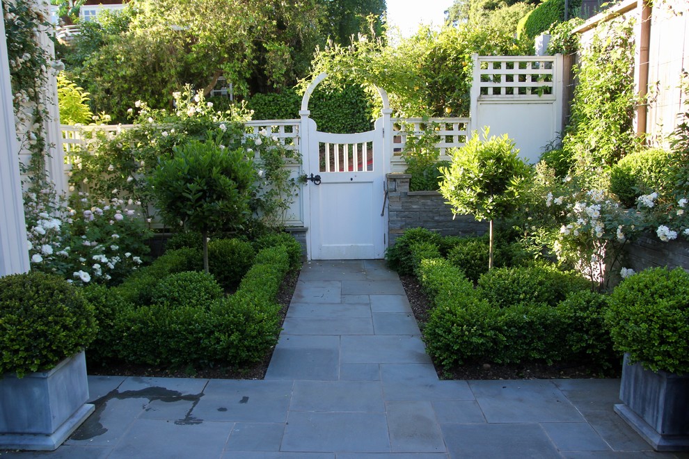 Inspiration for a mid-sized victorian full sun backyard concrete paver formal garden in San Francisco.