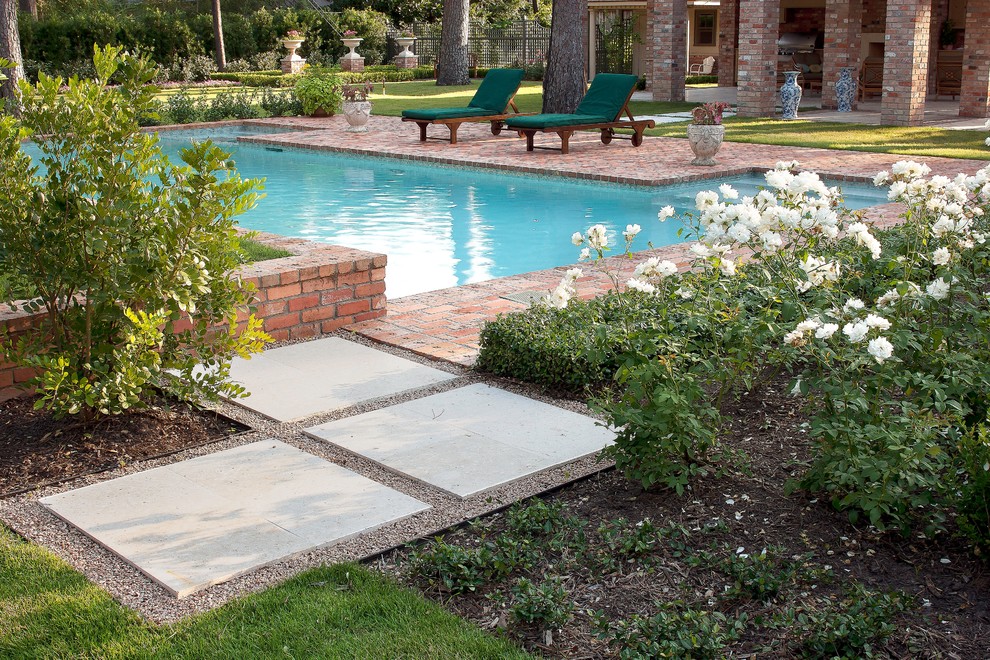 Inspiration for a medium sized traditional back formal partial sun garden for spring in Houston with brick paving.