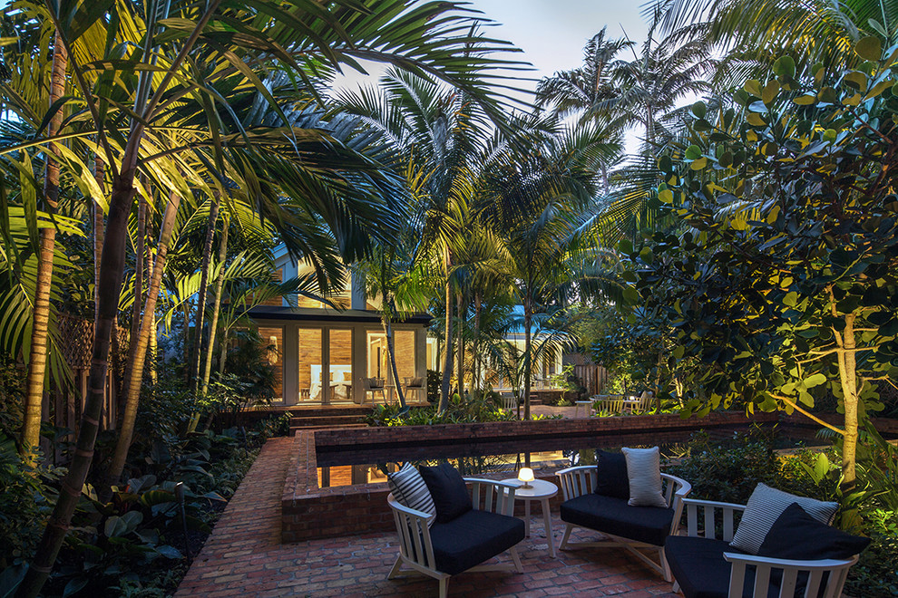 Medium sized world-inspired back full sun garden in Miami.