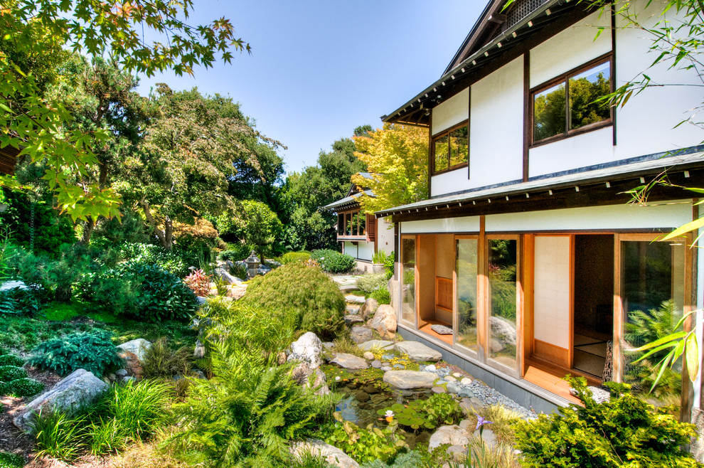 Design ideas for a large asian partial sun stone water fountain landscape in San Francisco for summer.