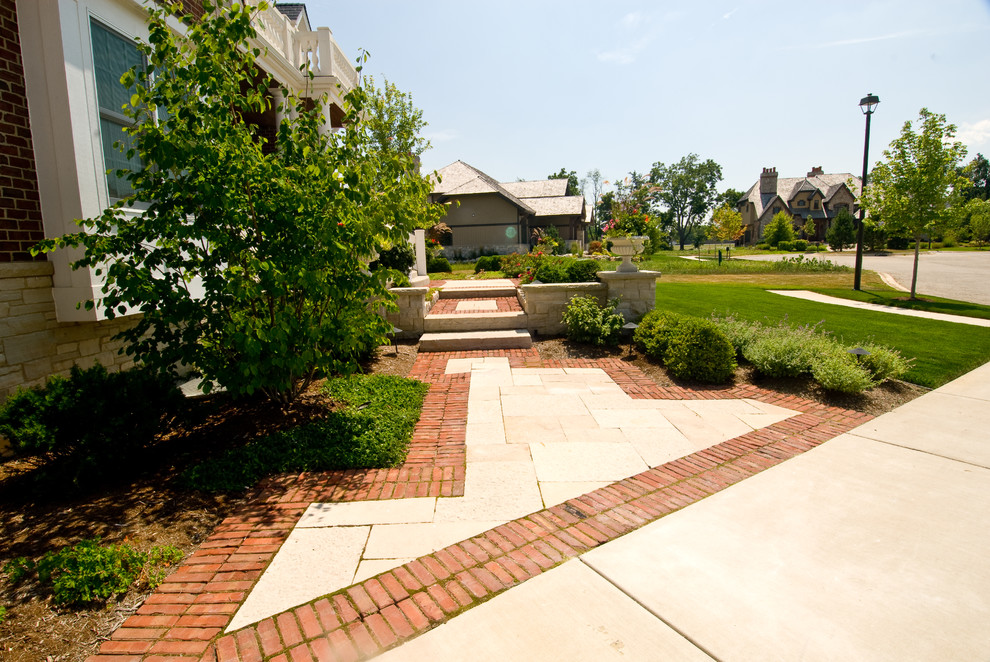 Photo of a large traditional full sun front yard stone landscaping in Chicago for summer.