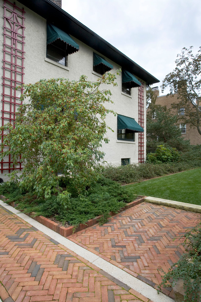This is an example of a large traditional backyard brick garden path in Chicago.