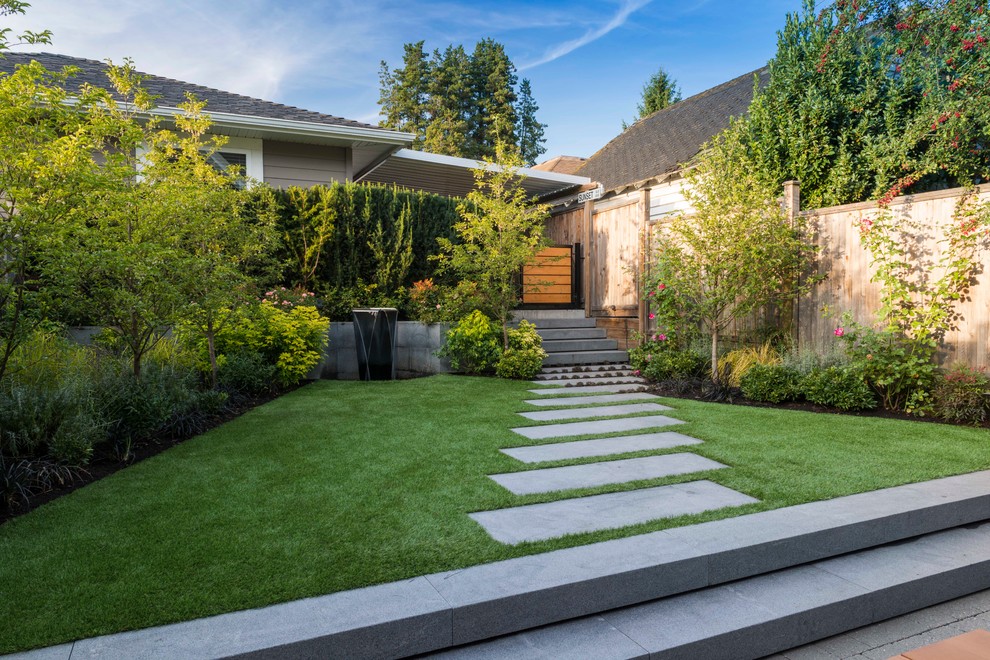 Photo of a small contemporary partial sun backyard stone garden path in Vancouver.
