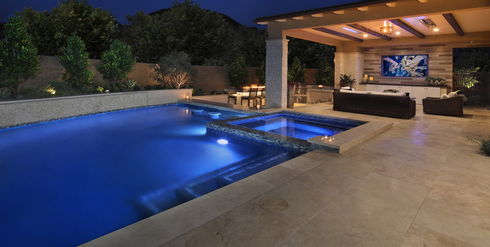 Photo of a beach style swimming pool in Orange County with a water feature.