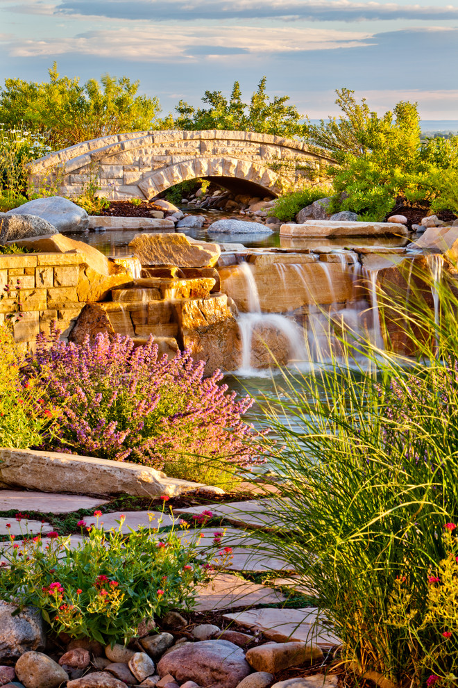 Design ideas for a large traditional full sun backyard stone landscaping in Denver.