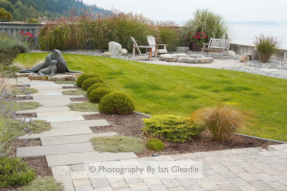 Design ideas for a mid-sized coastal partial sun backyard concrete paver landscaping in Seattle.