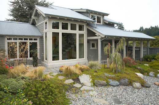 Photo of a mid-sized coastal partial sun backyard concrete paver garden path in Seattle.
