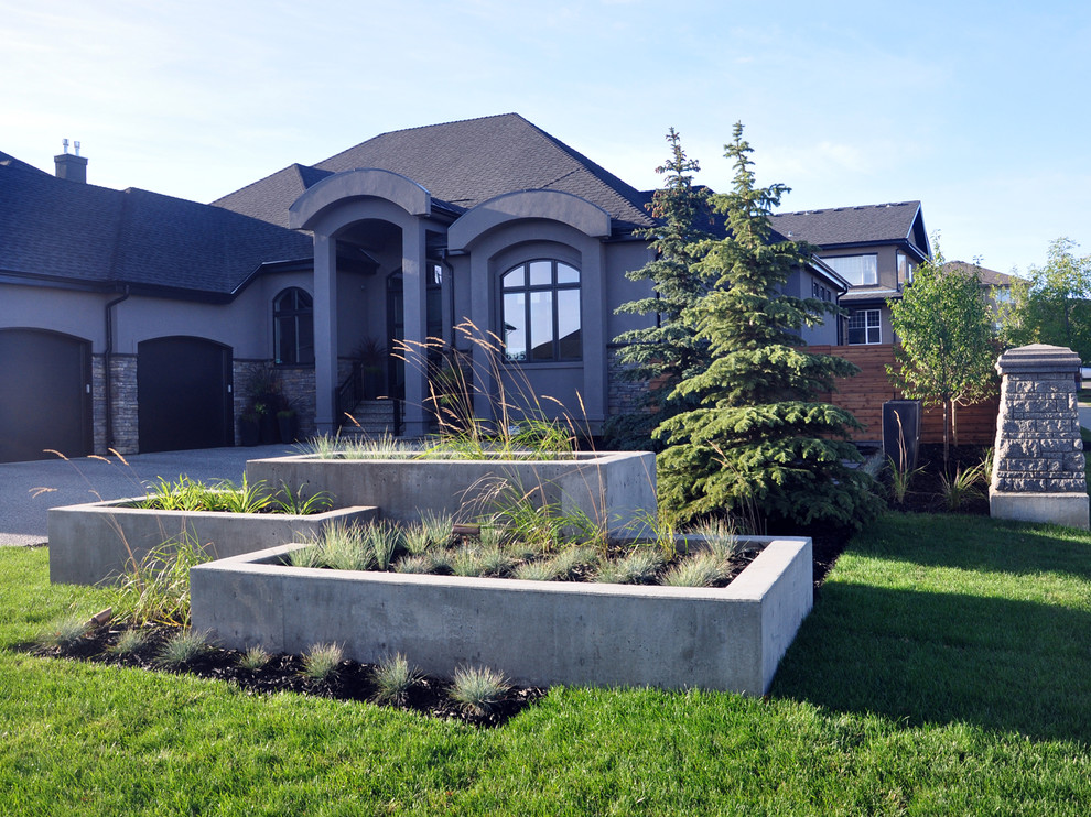 This is an example of a large modern back garden in Vancouver with a water feature and concrete paving.