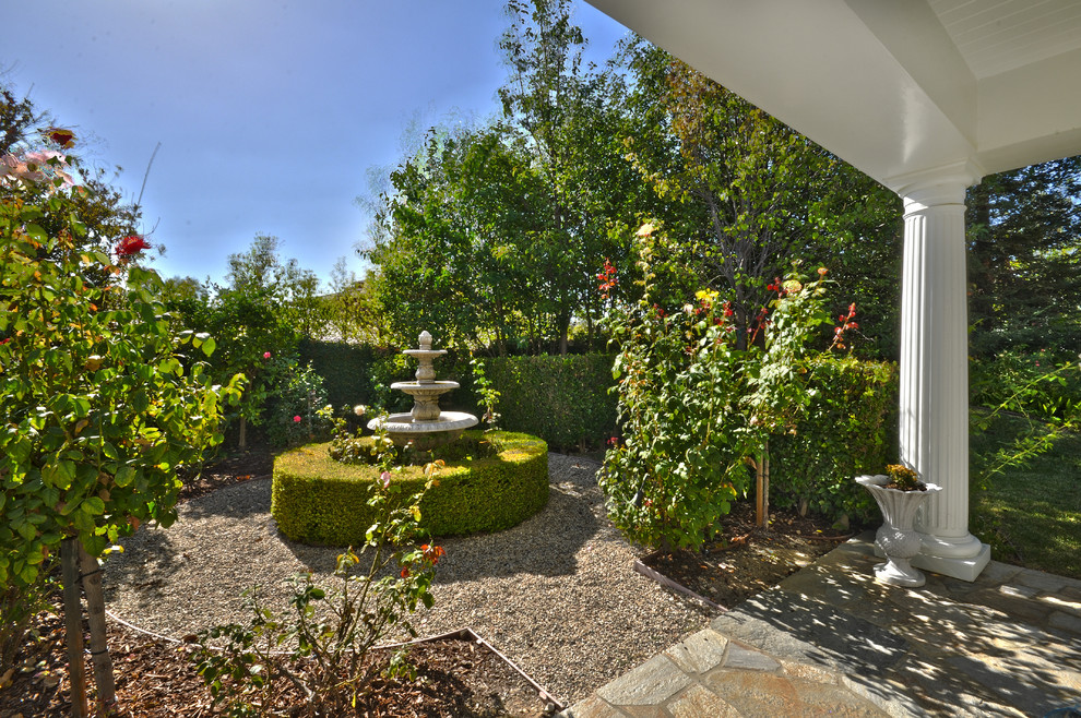На фото: солнечный, летний регулярный сад среднего размера на боковом дворе в классическом стиле с хорошей освещенностью и покрытием из гравия