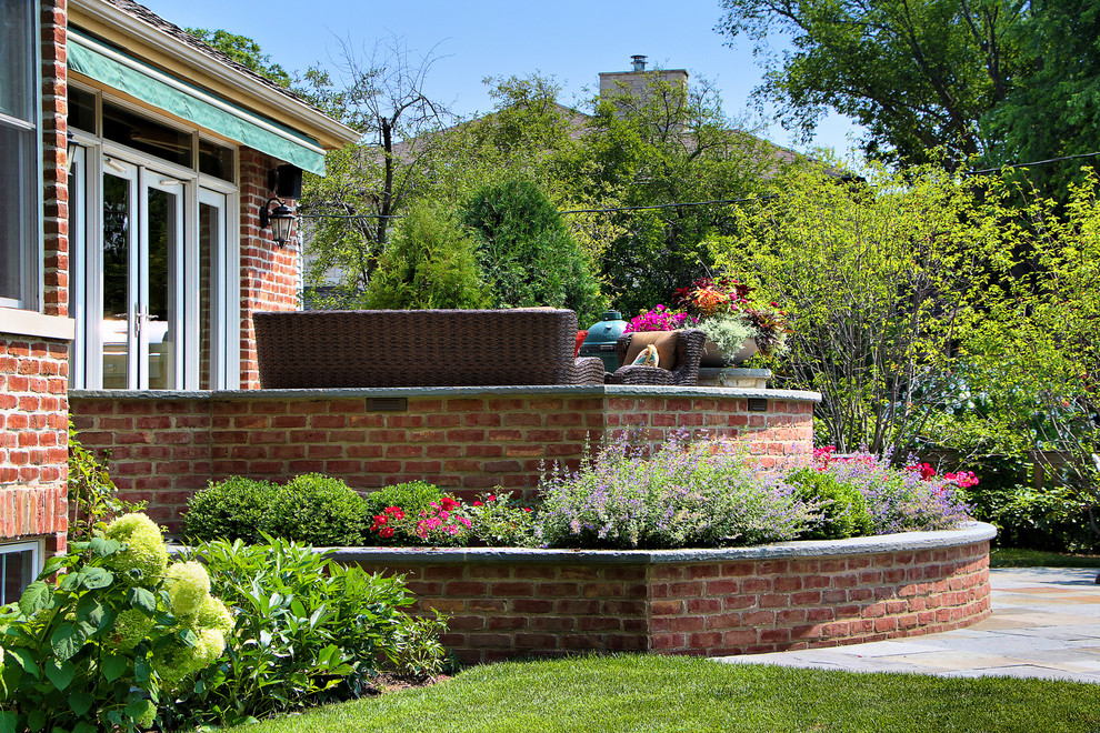 This is an example of a traditional backyard stone retaining wall landscape in Chicago.
