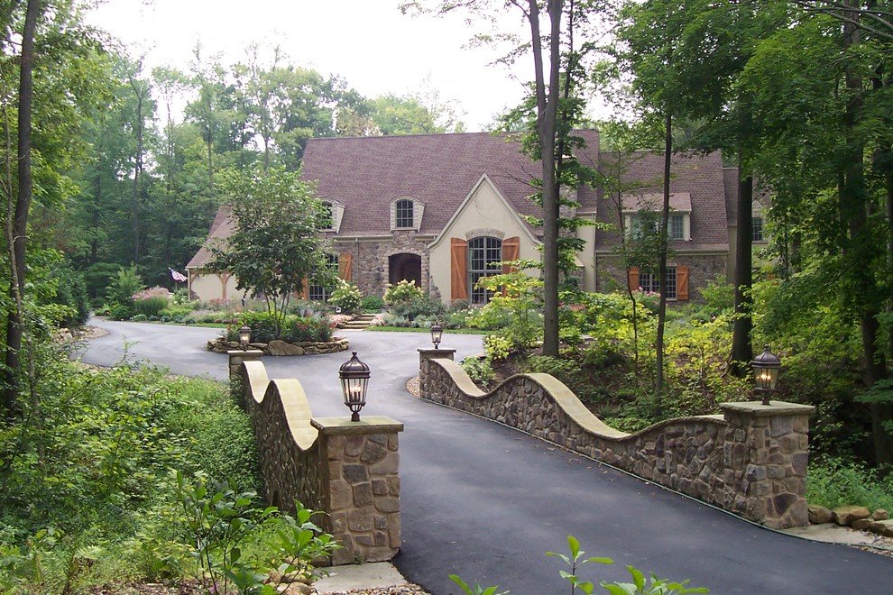 Design ideas for a large front driveway fully shaded garden for summer in Cleveland.