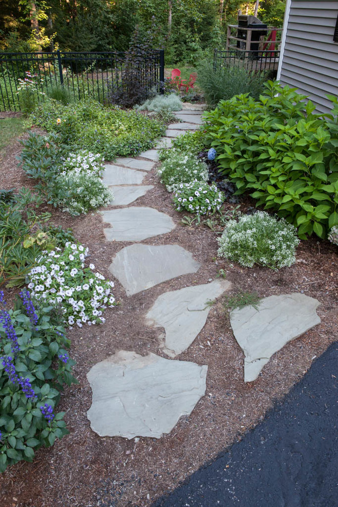 This is an example of a large transitional partial sun backyard mulch garden path in Other for summer.