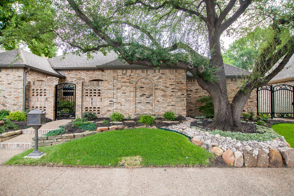 Photo of a medium sized eclectic front xeriscape full sun garden in Dallas with a garden path and natural stone paving.
