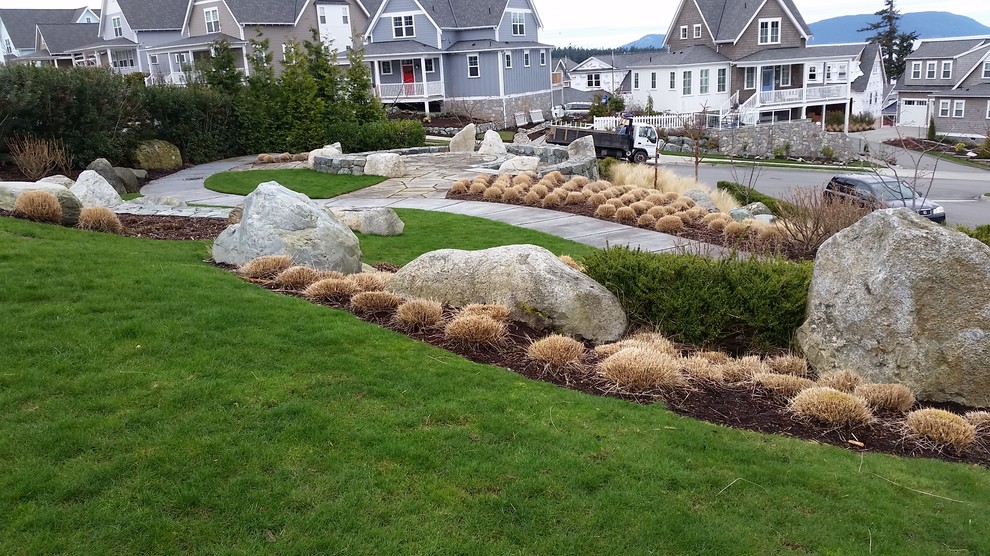 Inspiration for a large craftsman hillside stone retaining wall landscape in Seattle.