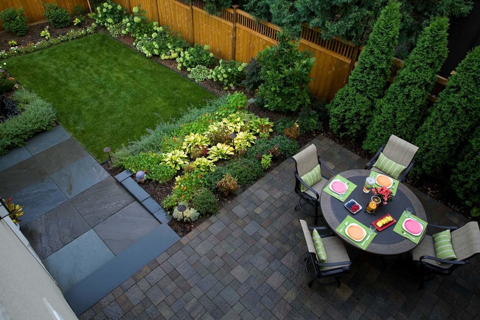Small contemporary back fully shaded garden for summer in Minneapolis with natural stone paving and a vegetable patch.