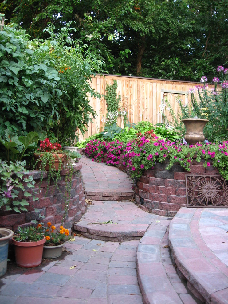 他の地域にある広いトランジショナルスタイルのおしゃれな裏庭 (庭への小道、日向、レンガ敷き) の写真