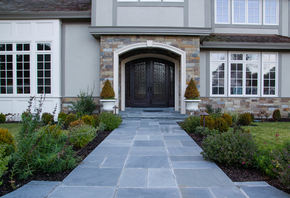 This is an example of a large traditional partial sun front yard concrete paver landscaping in San Francisco.
