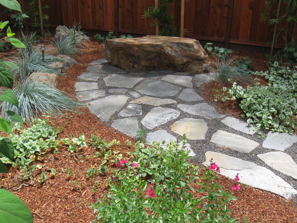 Inspiration for a mid-sized traditional partial sun backyard stone landscaping in San Francisco.