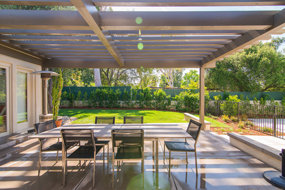 This is an example of a large contemporary partial sun backyard concrete paver formal garden in Los Angeles for summer.