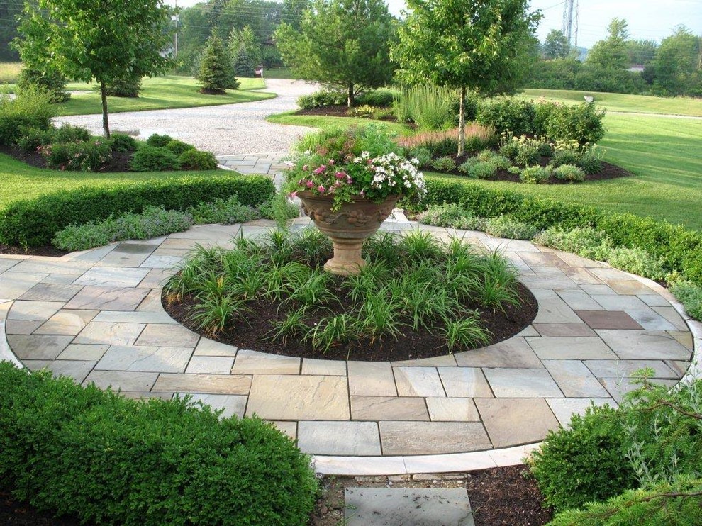 This is an example of a large traditional full sun backyard stone landscaping in Other.
