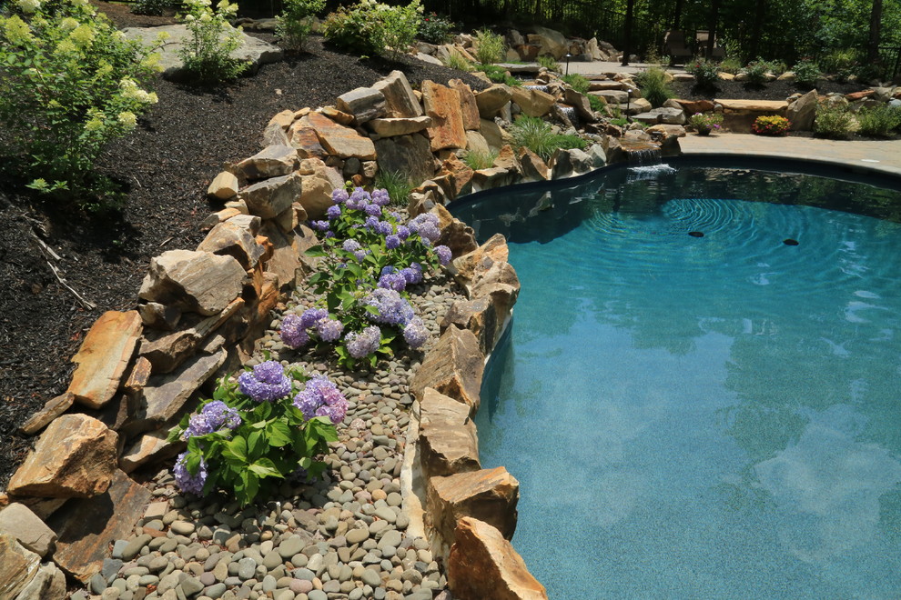 Design ideas for a large rustic full sun backyard water fountain landscape in Bridgeport for summer.