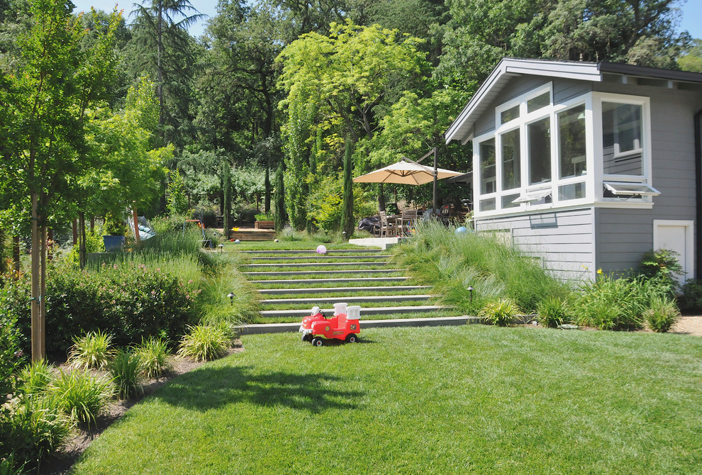 Immagine di un giardino chic esposto in pieno sole con un pendio, una collina o una riva e scale