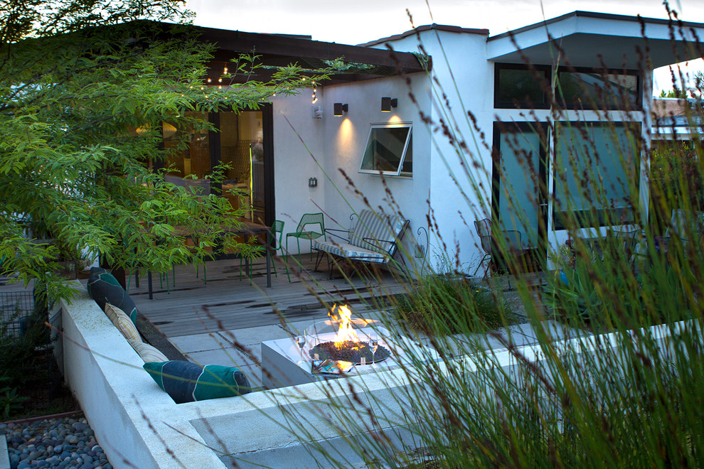 Inspiration for a medium sized contemporary back xeriscape garden in Los Angeles with a fire feature and decking.